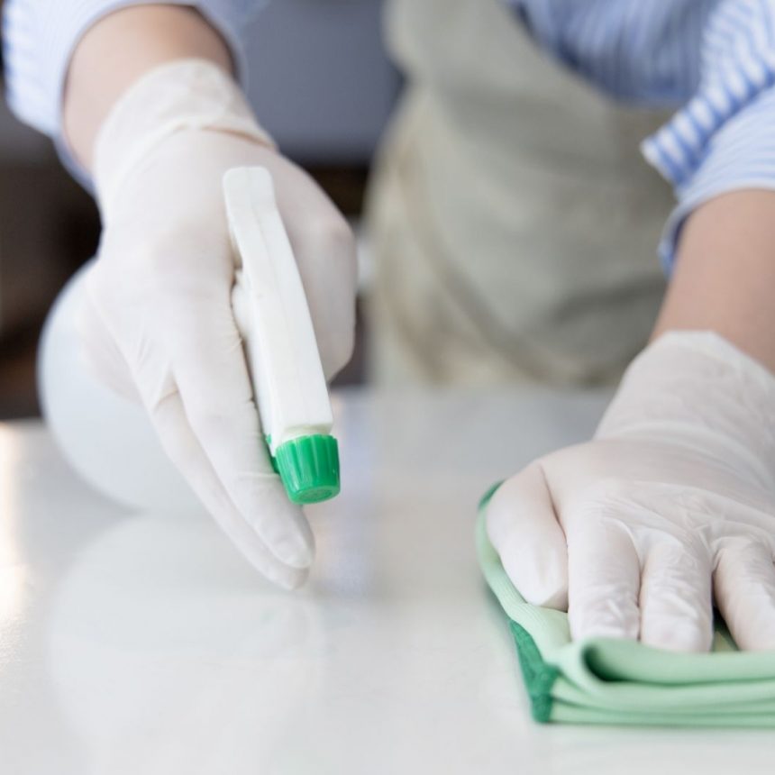 hands cleaning office. disinfecting desk.